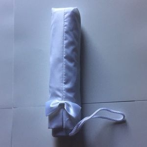 Umbrella wedding white with a small bow.